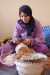A Maroccan woman peeling argan nuts